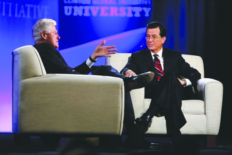 Jeff Roberson/AP
Former President Clinton and Comedy Central's Stephen Colbert answer questions from the audience during the Clinton Global Initiative at Washington University on  Saturday in St. Louis.