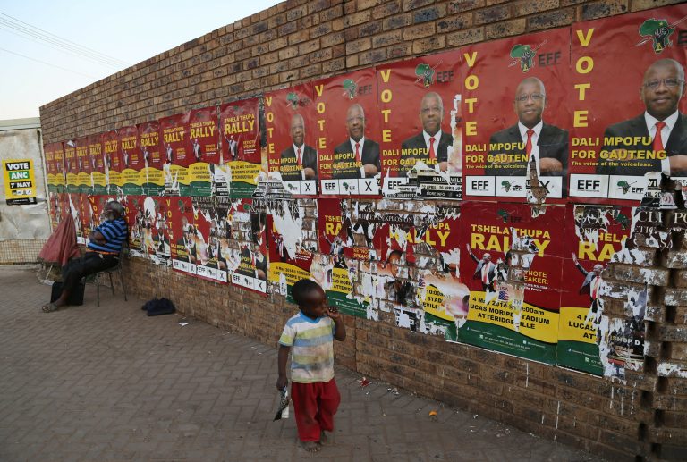 A child walks past the Economic Freedom Fighters (EFF) election posters in Atteridgeville, west of Pretoria, South Africa,  Monday May 5, 2014. South African President Jacob Zuma said Monday that he anticipates an election victory this week for the ruling African National Congress, and that his government, if re-elected, will speed the provision of basic services following protests in many poor communities that complain they are sidelined. (AP Photo/Themba Hadebe)