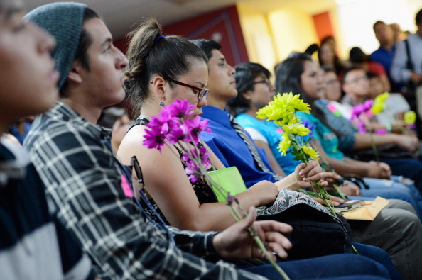 LOS ANGELES, CA - AUGUST 15:  A group of immigrants, known as DREAMers, hold flowers as they listen to a news conference to kick off a new program called  Deferred Action for Childhood Arrivals at the Coalition for Humane Immigrant Rights of Los Angeles on August 15, 2012 in Los Angeles, California. Under a new program established by the Obama administration undocumented youth who qualify for the program, called Deferred Action for Childhood Arrivals, can file applications from the U.S. Citizenship and Immigration Services website to avoid deportation and obtain the right to work  (Photo by Kevork Djansezian/Getty Images)
