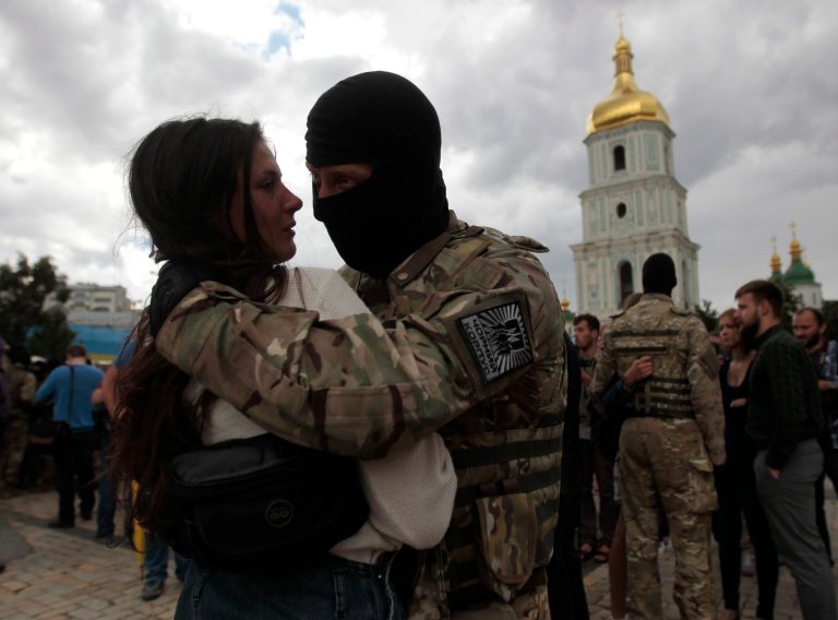 A girl says goodbye to her friend, a volunteer, before they are sent to the eastern part of Ukraine to join the ranks of special battalion 