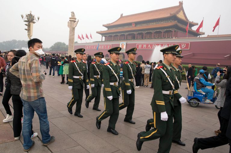 In this photo taken Saturday, Oct. 11, 2014, Chinese paramilitary policemen march across Tiananmen Gate in Beijing, China. The most important meeting of the year for the 205 members of Chinaâs ruling Communist Partyâs Central Committee, beginning Monday, Oct 20, 2014, will focus on how to rule the country in accordance with law.(AP Photo/Ng Han Guan)