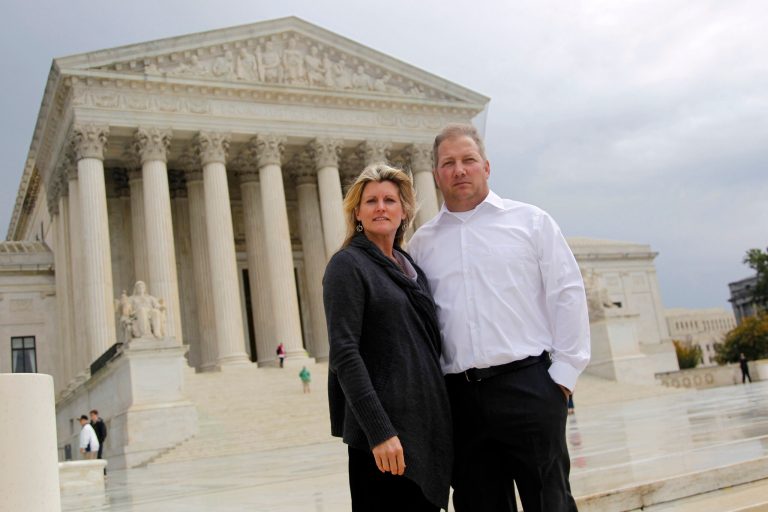 Mike and Chantell Sackett of Priest Lake, Idaho, pose for a photo in front of the Supreme Court in Washington. 