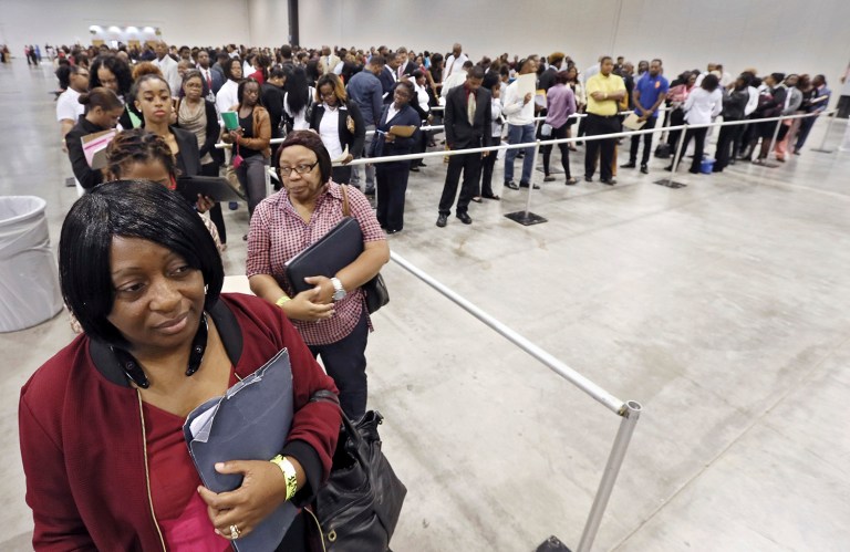 Kanockwa Horton, left, from Stone Mountain and Jacqueline Merritt, from Atlanta are first in line at the Airport Community Job Fair, on Wednesday, Oct. 19, 2016, in Atlanta. Hundreds of applicants were in line before the 10 a.m. opening. (Bob Andres/Atlanta Journal-Constitution via AP)