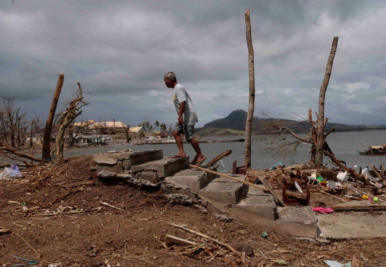 A resident prepares to rummage through the debris near the shoreline Thursday Nov. 14, 2013  at Tacloban city, Leyte province in central Philippines. Typhoon Haiyan, one of the most powerful storms on record, hit the country's eastern seaboard on Friday, destroying tens of thousands of buildings and displacing hundreds of thousands of people. (AP Photo/Bullit Marquez)