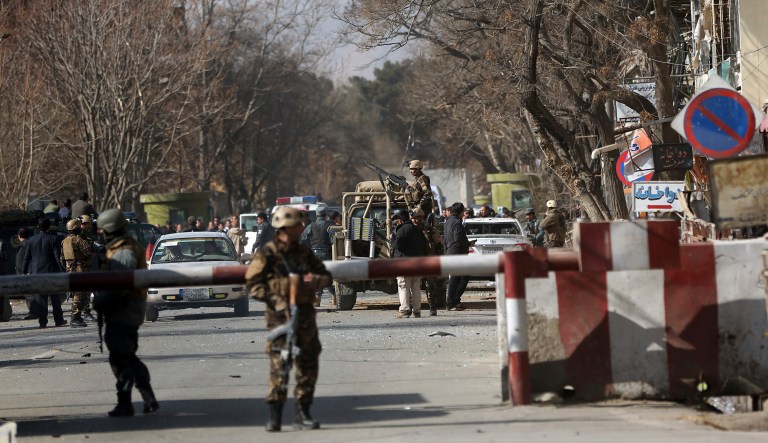 Security forces inspect at the site of a deadly suicide attack in the center of Kabul, Afghanistan on Saturday. A suicide car bomber killed at least 40 people and wounded about 140 more in an attack claimed by the Taliban on Saturday in Afghanistan's capital Kabul, authorities said. (AP Photo/Massoud Hossaini)