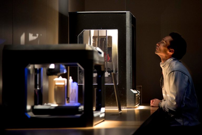 A trade show attendee examines various MakerBot 3D printers at the International Consumer Electronics Show on Wednesday in Las Vegas. (AP Photo/Julie Jacobson)