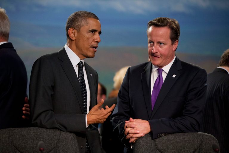 U.S. President Barack Obama and British Prime Minister David Cameron, right, speak before taking their seats at the start of a NATO-Afghanistan round table meeting during a NATO summit at the Celtic Manor Resort in Newport, Wales on Thursday, Sept. 4, 2014. In a two-day summit leaders will discuss, among other issues, the situation in Ukraine and Afghanistan.  (AP Photo/Matt Dunham)