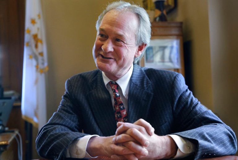 In this Thursday, Dec. 11, 2014 photo Rhode Island Gov. Lincoln Chafee responds to questions during an interview with The Associated Press, in his office at the Statehouse, in Providence, R.I. (AP Photo/Steven Senne)