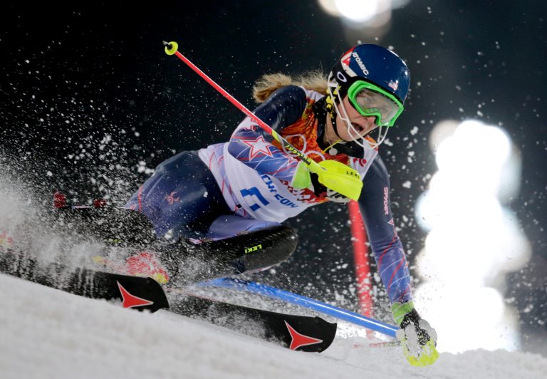Gold medal winner Mikaela Shiffrin skis past a gate in the women's slalom at the Sochi 2014 Winter Olympics, Friday, Feb. 21, 2014, in Krasnaya Polyana, Russia. (AP Photo/Charles Krupa)