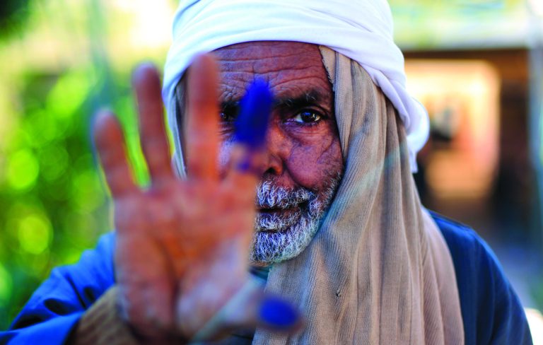 An Egyptian elderly man shows his inked finger after casting his vote on the second round of a referendum on a disputed constitution drafted by Islamist supporters of President Mohammed Morsi in Fayoum, about 100 kilometers (62 miles) south of Cairo , Egypt, Saturday, Dec. 22, 2012.(AP Photo/Khalil Hamra)