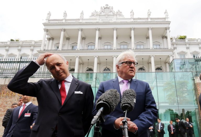 French Foreign Minister Laurent Fabius and German Foreign Minister Frank-Walter Steinmeier, from left, brief the media in front of Coburg where closed-door nuclear talks with Iran continue in Vienna, Austria, Monday, July 13, 2015. (AP Photo/Ronald Zak)