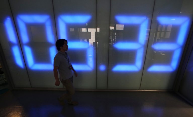 A foreign exchange company employee walks in front of an electric monitor displaying the current exchange rate of Japanese yen against U.S. dollar in Tokyo, Friday, Sept. 5, 2014. The U.S. dollar rose to around 105.70 yen, the highest since October 2008, on Friday morning. (AP Photo/Koji Sasahara)