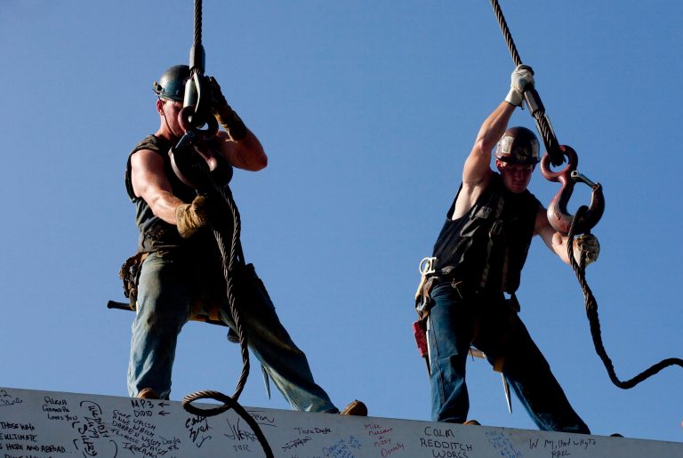 In this Thursday, Aug. 2, 2012 photo, ironworkers James Brady, left, and Billy Geoghan release the cables from a steel beam after connecting it on the 104th floor of 1 World Trade Center, in New York. U.S. employers added 163,000 jobs in July, a hopeful sign after three months of sluggish hiring. The Labor Department said Friday, Aug. 3, 2012, that the unemployment rate rose to 8.3 percent from 8.2 percent in June. July's hiring was the best since February. Still, the economy has added an average of 151,000 jobs a month this year, roughly the same as last year's pace. That's not enough to satisfy the 12.8 million Americans who are unemployed.  (AP Photo/Mark Lennihan)