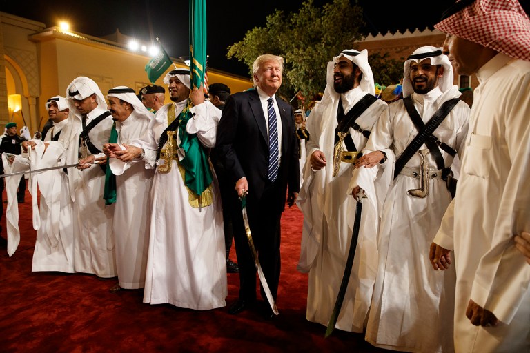 President Donald Trump holds a sword and sways with traditional dancers during a welcome ceremony at Murabba Palace, Saturday, May 20, 2017, in Riyadh. (AP Photo/Evan Vucci)