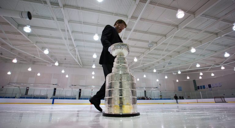   Mike Bolt, keeper of the Stanley Cup, takes it off the ice after members of the Vancouver Angels novice C1 minor hockey team were surprised with it before their youth practice Friday, Dec. 7, 2012, in Vancouver, British Columbia. Five minor hockey teams in Canada were randomly chosen to receive a surprise appearance by the Stanley Cup as part of the Scotiabank Community Hockey Sponsorship Program. The NHL lockout is in its 82nd day. (AP Photo/The Canadian Press, Darryl Dyck)  