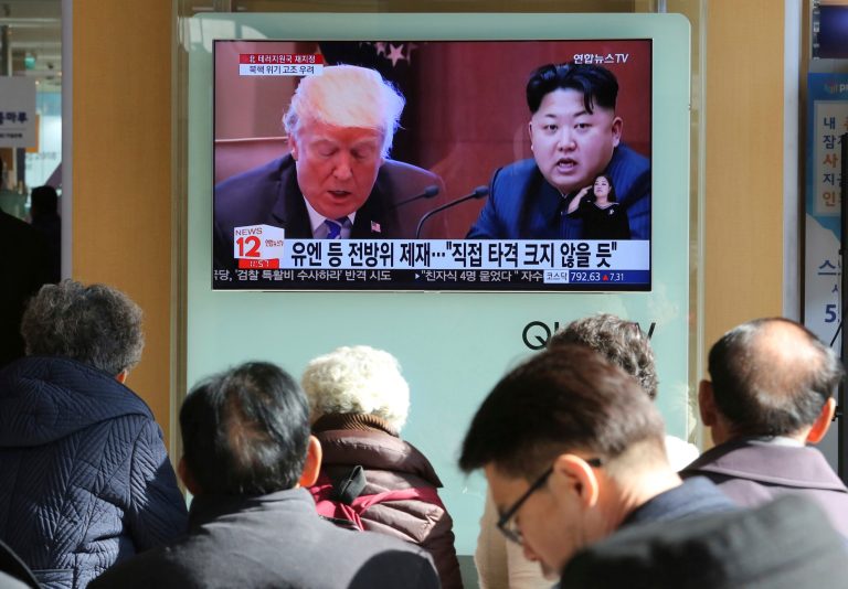 People watch a TV screen showing images of U.S. President Donald Trump, left, and North Korean leader Kim Jong Un at Seoul Railway Station in Seoul, South Korea. (AP Photo/Ahn Young-joon, File)
