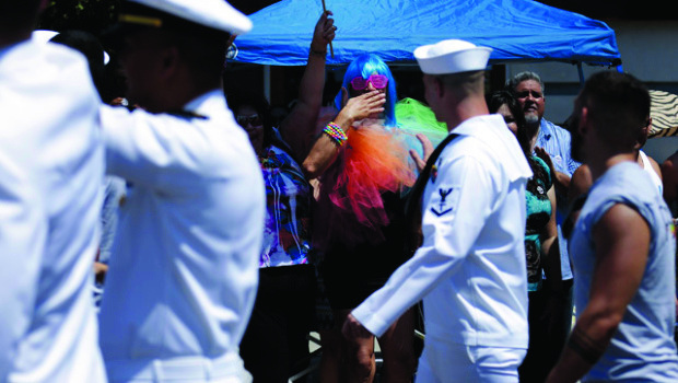 A man blows a kiss to Navy sailors marching in uniform during the gay pride parade Saturday, July 21, 2012, in San Diego. (AP Photo/Gregory Bull)