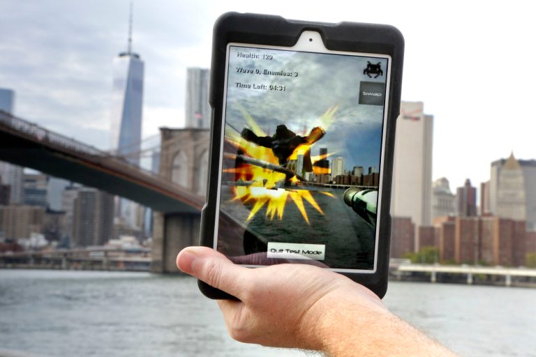 An example of what an Augmented Reality app video game would look like being played with the Epson Moverio BT-200 Smart Glasses, is displayed on a tablet from Brooklyn Bridge Park, Tuesday, Oct. 7, 2014, in New York. Players can use their natural surroundings as the backdrop for the game with the game's graphics displayed through the glasses instead of on a screen. (AP Photo/Julie Jacobson)