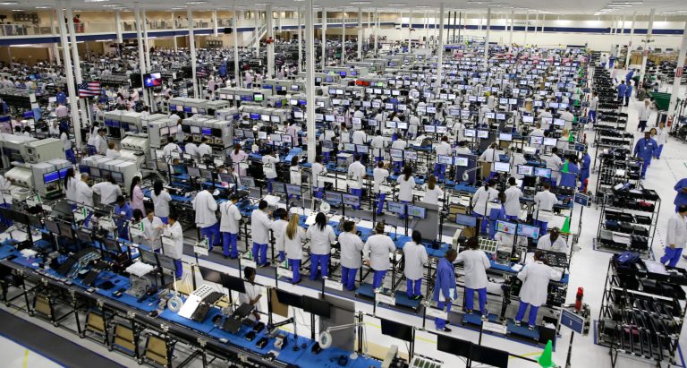 FILE - In this  Tuesday, Sept. 10, 2013, file photo, workers man the Motorola smartphone plant in Fort Worth, Texas. The Commerce Department reports how much wholesalers adjusted their stockpiles in September and how much their sales changed on Friday, Nov. 15, 2013. (AP Photo/LM Otero, File)