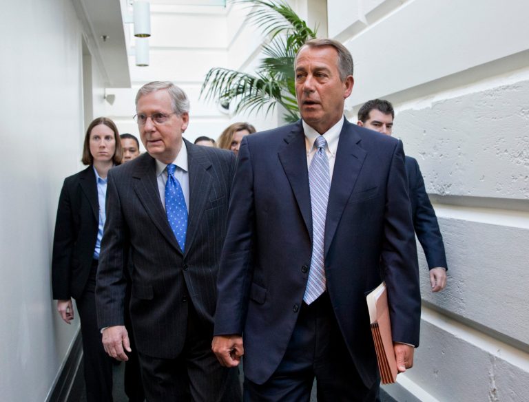 House Speaker John Boehner of Ohio, right, walks with Senate Minority Leader Mitch McConnell of Ky., left, as they make their way to a GOP strategy session on Capitol Hill in Washington, Tuesday, Nov. 19, 2013. (AP Photo/J. Scott Applewhite)