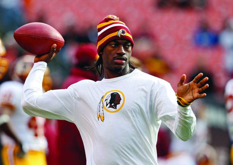Rick Osentoski/AP
Washington Redskins quarterback Robert Griffin III will play Sunday if cleared by the doctors.