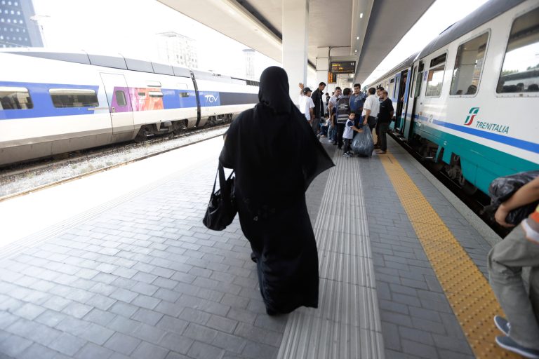 In this picture taken Thursday, June 11, 2014, Syrian refugees arrive at the Garibaldi train station in Milan, Italy. Every day, boatloads of refugees arrive on Italian shores. European Union law requires Italy to fingerprint them, so that if they apply for asylum in another country they can be sent back to their port of entry. Instead, Italy is helping thousands of undocumented migrants slip quietly into northern Europe, with no record of their time in Italy.  (AP Photo/Luca Bruno)
