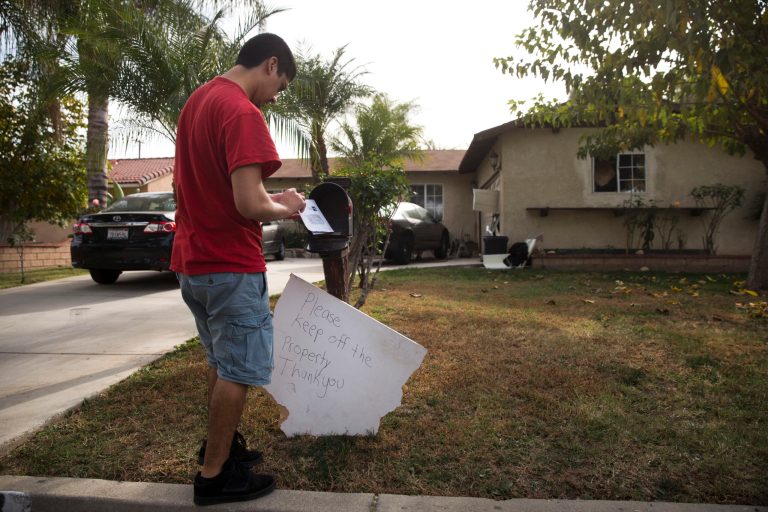 A brother of Enrique Marquez collects his mail in Riverside, Calif. The indictment centers around a fraudulent marriage between Chernkykh and Enrqiue Marquez, a friend of Syed Rizwan Farook who has since been charged with aiding him and his wife, Tashfeen Malik, in the Dec. 2 terror attack that left 14 people dead. (AP Photo/Jae C. Hong)