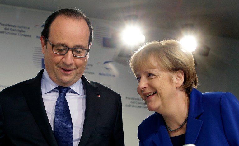 France's President Francois Hollande, left, and Germany's Federal Chancellor Angela Merkel arrive for a press conference during the EU jobs summit in Milan, Italy, Wednesday, Oct. 8, 2014. European leaders will debate ways to find work for the continent's 25 million unemployed at a summit Wednesday, as popular frustration grows at authorities' failure to return the continent's economy to health. Several thousand union activists protested outside the venue, demanding a stop to government spending austerity policies and calling for reforms to encourage investment. (AP Photo/Antonio Calanni)