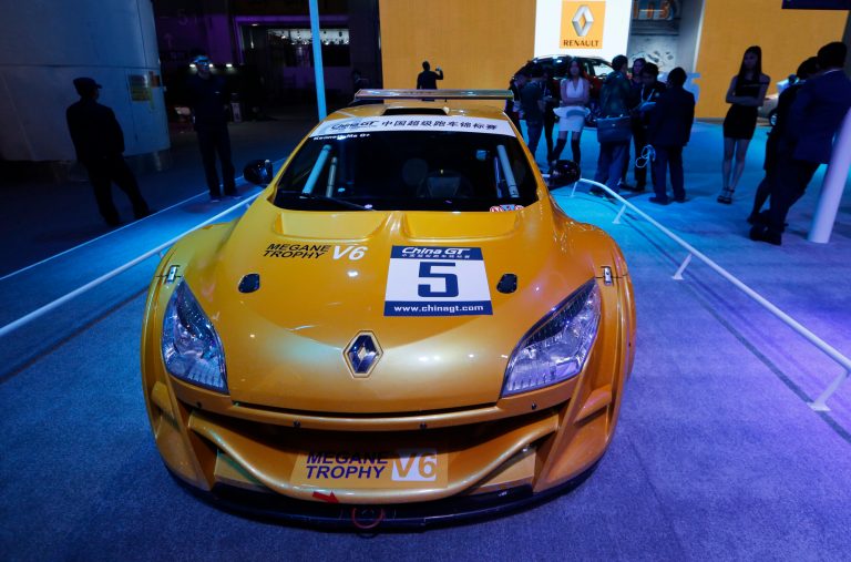 In this Nov. 21, 2013 photo, Renault Megane Tropy race car is displayed at the company's booth during Guangzhou 2013 Auto Show in China's southern city of Guangzhou. French automakers Renault and Peugeot are looking belatedly to China to revive their flagging fortunes but picked a tough time to try to expand. (AP Photo/Kin Cheung)
