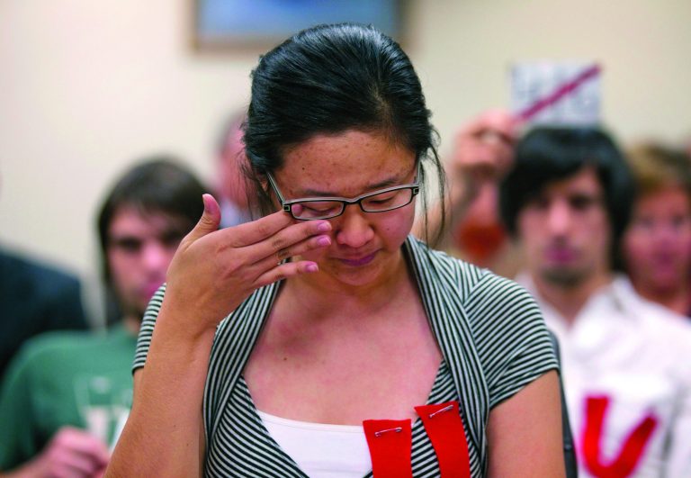 FILE - In this Nov. 8, 2011 file photo, illegal immigrant Keish Kim, 20, wipes a tear away while addressing a committee of the Board of Regents of the University System of Georgia in Atlanta. A policy shift announced by President Barack Obama in June essentially gives certain young people brought to this country illegally immunity from deportation for at least two years and the chance to apply for a work permit. Now Kim and young activist leaders are deciding whether it's worth accepting a deal that falls far short of their demands. (AP Photo/David Goldman, File)