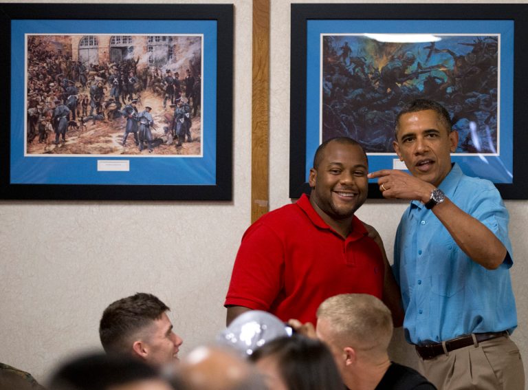   President Barack Obama visits with members of the military and their families in Anderson Hall at Marine Corp Base Hawaii, Tuesday, Dec. 25, 2012, in Kaneohe Bay, Hawaii. The first family is in Hawaii for a holiday vacation. (AP Photo/Carolyn Kaster)  