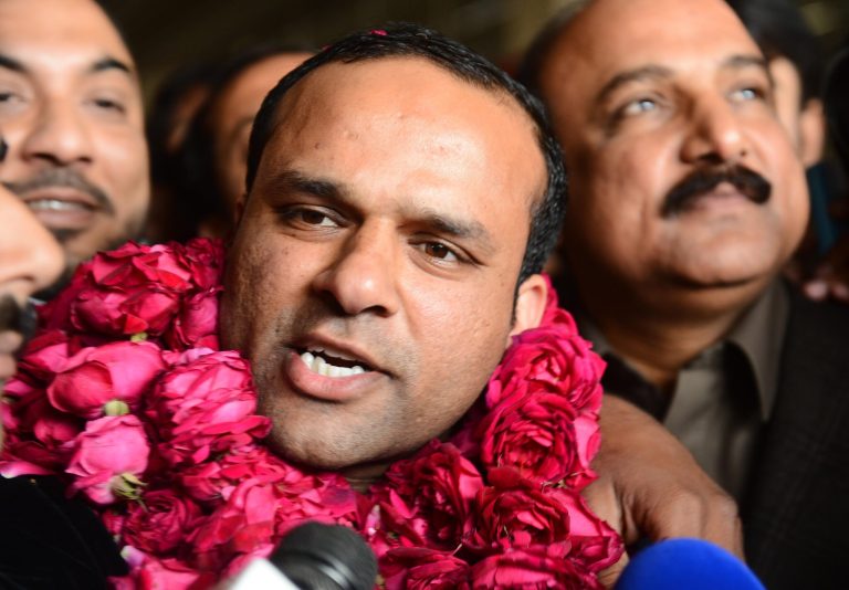   In this picture taken on Thursday, Dec. 27, 2012, Pakistani fans receive Muhammad Shahid Nazir, center, who sings 