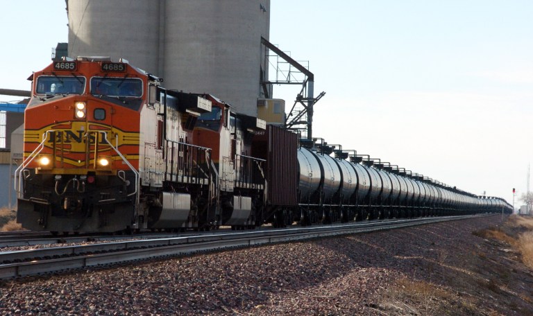 FILE - This Nov. 6, 2013, file photo shows a BNSF Railway train hauling crude oil near Wolf Point, Mont. Thousands of older rail tank cars that carry crude oil would be phased out within two years under regulations proposed in response to a series of fiery train crashes over the past year. Transportation Secretary Anthony Foxx said the government's testing of crude oil from the Bakken region of North Dakota and Montana shows the oil is on the high end of a range of volatility compared with other crude oils, meaning it's more likely to ignite if spilled. (AP Photo/Matthew Brown, File)