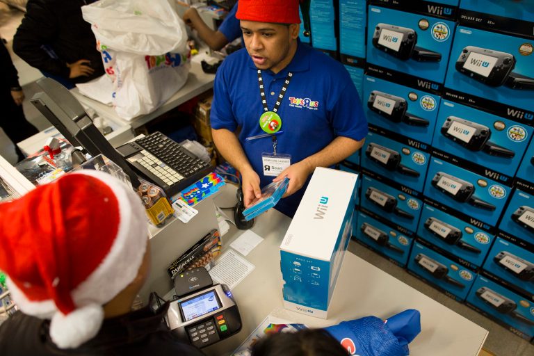 A customer makes a purchase in the flagship Toys 'R' Us store in New York's Times Square in2012. The retailer, which filed for bankruptcy last year, is closing all its U.S. stores.  