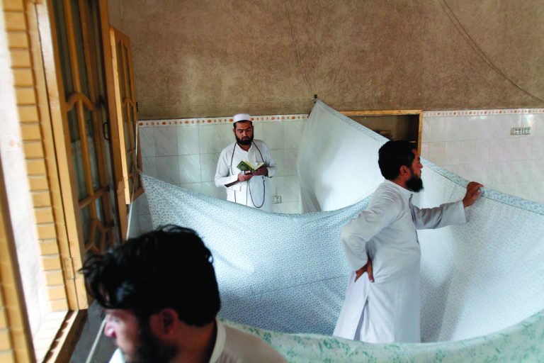 An Afghan Muslim devotee, who lives and prays in isolation in a mosque during Itikaf, the last ten days of the Islamic fasting month of Ramadan, reads from the Quran in the city of Jalalabad east of Kabul, Afghanistan, Tuesday, Aug. 14, 2012. The last ten days of Ramadan, known as Itikaf, are very important according to many Muslims due to the belief that Prophet Muhammad used to exert himself even more in worship, hoping to draw himself closer to God. Itikaf involves total dedication to worship, reading Quran, and supplication. (AP Photo/Rahmat Gul)