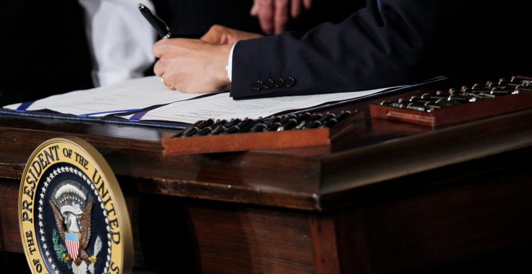   FILE - This March 23, 2010 file photo shows Ttwenty two pens next to President Barack Obama as he signs the health care reform bill in the East Room of the White House in Washington. Your medical plan is facing an unexpected expense, so you probably are, too. It's a new, $63-per-head fee to cushion the cost of covering people with pre-existing conditions under President Barack Obamaâs health overhaul. The charge, buried in a recent regulation, works out to tens of millions of dollars for the largest company health plans, and much of that is likely to be passed on to employees. Multiple pens are used to sign legislation, and then distributed to supporters of the legislation. (AP Photo/Charles Dharapak, File)  