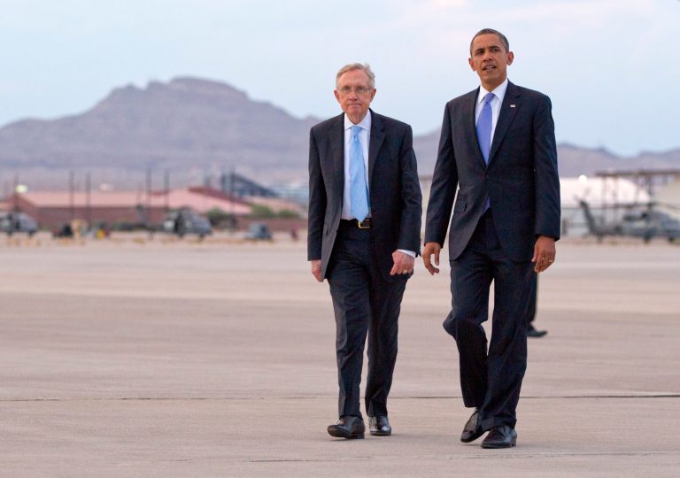 President Obama and Senate Majority Leader Harry Reid walk together on the tarmac as they arrive at Nellis Air Force Base in Las Vegas in August 2012. (AP Photo/Carolyn Kaster)