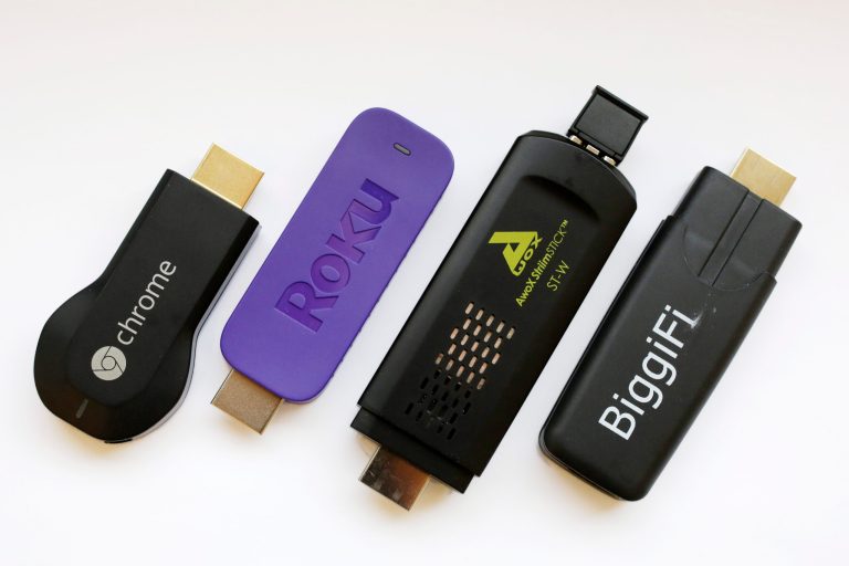 This April 24, 2014 photo shows four streaming stick devices, from lef: Google Chromecast, Roku Streaming Stick, AwoX StriimStick, and BiggiFi, in New York. (AP Photo/Mark Lennihan)