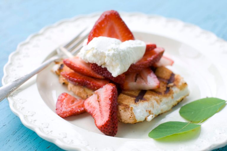  This May 30, 2012 image shows a dessert of spiced and grilled angel food cake with strawberries and whipped cream in Concord, N.H. (AP Photo/Matthew Mead)  