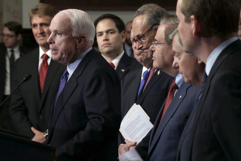 WASHINGTON, DC - APRIL 18:  U.S. Sen. John McCain (R-AZ) (2nd L) speaks as (L-R) Sen. Jeff Flake (R-AZ), Sen. Marco Rubio (R-FL), Sen. Richard Durbin (D-IL), Sen. Chuck Schumer (D-NY), Sen. Bob Menendez (D-NJ), Sen. Lindsey Graham (R-SC), and Sen. Michael Bennet (D-CO), also known as the Gang of Eight, listen during a news conference on immigration reform April 18, 2013 on Capitol Hill in Washington, DC. The senators discussed the 