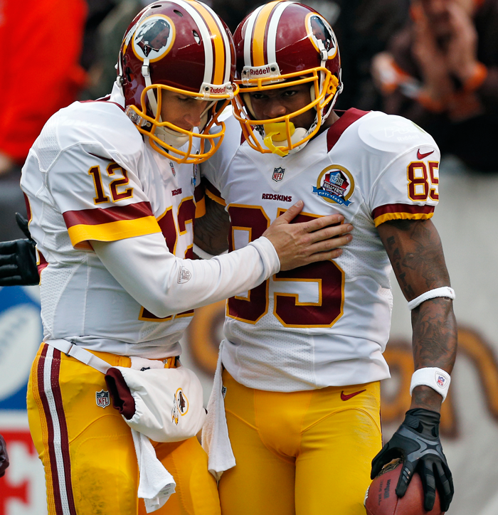 Kirk Cousins (12) congratulates wide receiver Leonard Hankerson after a 54-yard touchdown pass in the first quarter of an NFL football game against the Cleveland Browns on Sunday. (AP Photo/Rick Osentoski)