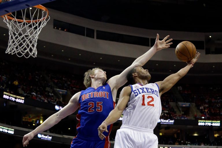   Philadelphia 76ers' Evan Turner (12) pulls in a rebound against Detroit Pistons' Kyle Singler (25) in the first half of an NBA basketball game, Monday, Dec. 10, 2012, in Philadelphia. (AP Photo/Matt Slocum)  