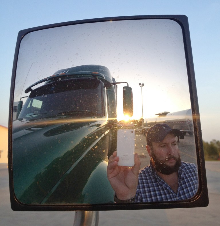 This undated image provided by James Weitze shows a truck driver taking a self portrait on the road. Weitze satisfies his video fix with an iPhone. He sleeps most of the time in his truck, and has no apartment. To be sure, he's an extreme case and probably wouldn't fit into Nielsen's definition of a household in the first place. But he's watching Netflix enough to keep up on shows like 