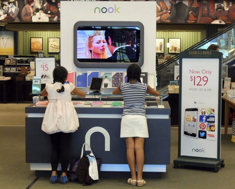 FILE - In this Friday, June 21, 2013 file photo, customers look at Nook tablets at a Barnes & Noble store in Pineville, N.C. Barnes & Noble on Wednesday, June 25, 2014 said it wants to split its retail bookstores and Nook media business into two separate public companies as it looks to boost shareholder value.  (AP Photo/Chuck Burton, File)
