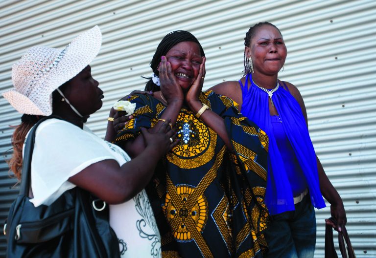 File - In this July 11, 2012 file photo, a South Sudanese migrant worker is comforted by her friends after two of her five children boarded a bus leaving to Ben Gurion airport enroute to South Sudan from Tel Aviv. Israel has quietly repatriated hundreds of Sudanese migrants in recent months, drawing accusations from the United Nations and rights groups that it has coerced the Africans into potentially life-threatening situations and possibly violated international norms for treating refugees. (AP Photo/Ariel Schalit, File)