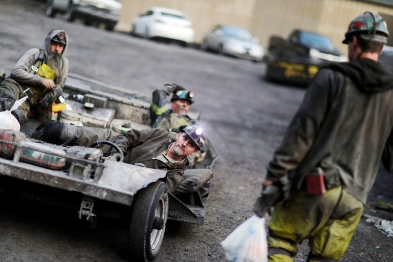 Coal miner Scottie Stinson, front, drives a man trip as he and fellow workers head into an underground mine less than 40-inches high to start their shift in Welch, W.Va. (AP Photo/David Goldman)