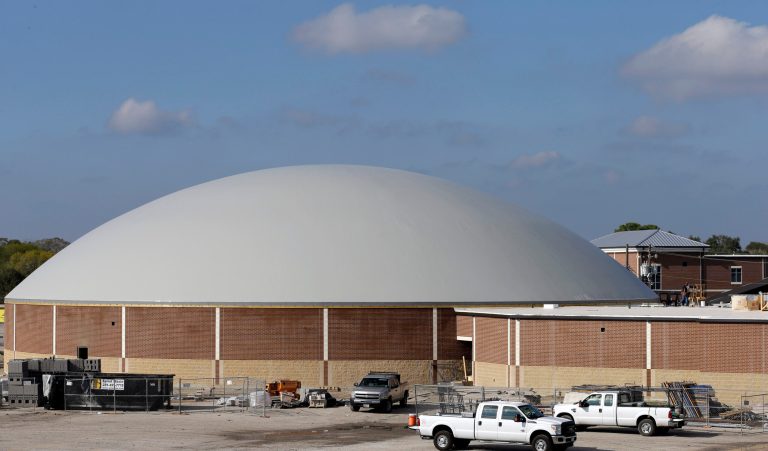   In this Thursday, Dec. 6, 2012 photo, work continues on the construction of a new domed gym at Edna High School in Edna, Texas. The hurricane dome, a structure being built in part with money from the Federal Emergency Management Agency, can be used to house first responders or residents evacuated during a storm. (AP Photo/David J. Phillip)  