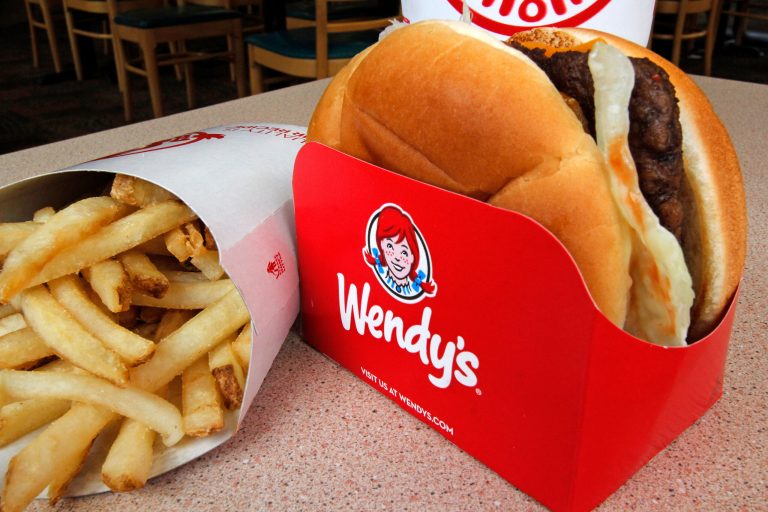 FILE - In this Monday, May 6, 2013, file photo shows a Wendy's single with cheese large combo meal at a Wendy's restaurant in Mt. Lebanon, Pa. Wendy's is rolling out a program that lets customers pay using their smartphones, following a similar plans unveiled by Burger King this week. (AP Photo/Gene J. Puskar, File)