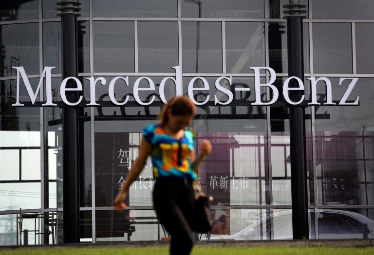 A woman walks past the Mercedes-Benz's dealer showroom in Beijing, China Monday, Aug. 18, 2014. China's government said Monday it has concluded Mercedes-Benz violated anti-monopoly law and charged excessive prices for parts, adding to a growing number of global automakers snared in an investigation of the industry. (AP Photo/Andy Wong)