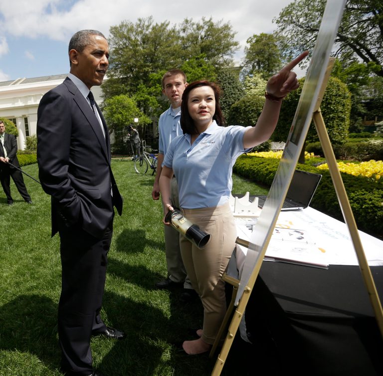 President Obama listens to Spencer Ottarson, 19, center, and Julie Xu, 17, right, both from Williamston, Mich., as they explain their 'Offshore Rip Current Alert System (ORCA), April 2013, during the White House Science Fair on the East Garden of the White House in Washington. (AP Photo/Pablo Martinez Monsivais)